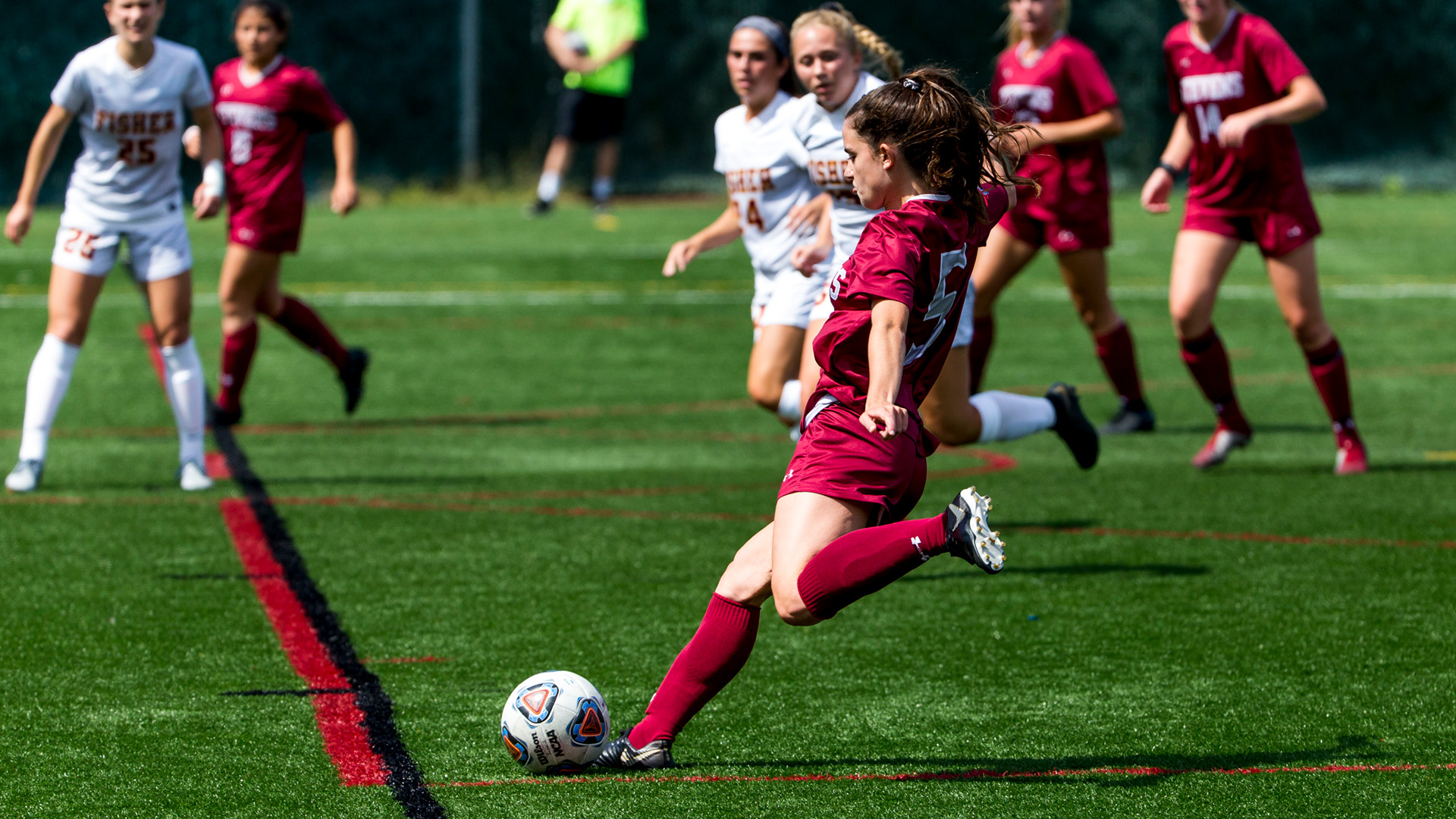 girl soccer player shooting and scoring